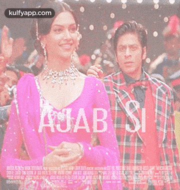 a woman in a pink dress is standing next to a man in a plaid shirt .