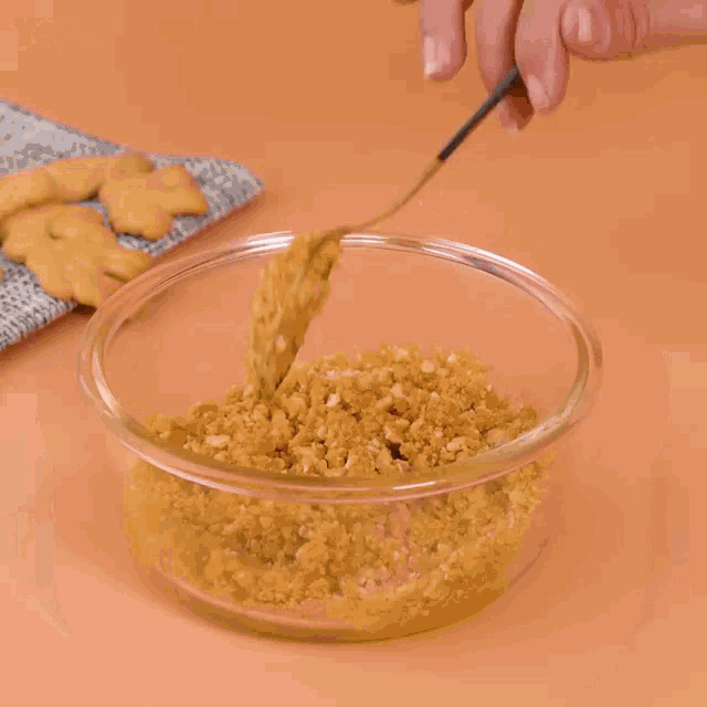 a person is holding a bowl of food that looks like a crumble
