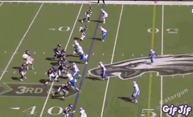 a football game is being played on a field with a gif written on the bottom