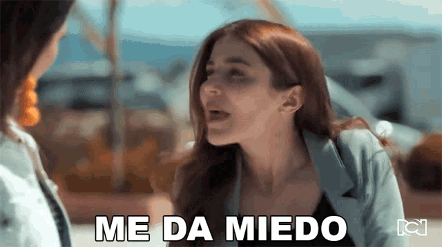 a woman says me da miedo while talking to another woman .