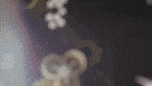 a close up of a purple background with a few circles and a few letters