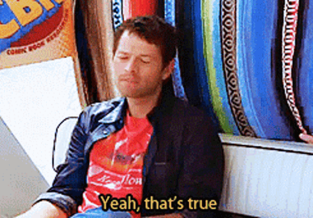 a man wearing a red shirt that says yeah that 's true on it