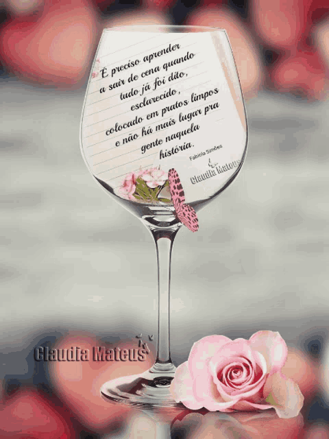 a wine glass with a note inside of it and the name claudia mateus on the bottom