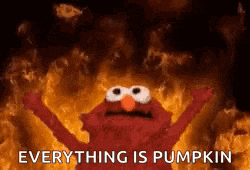 elmo from sesame street is standing in front of a fire with his arms outstretched .