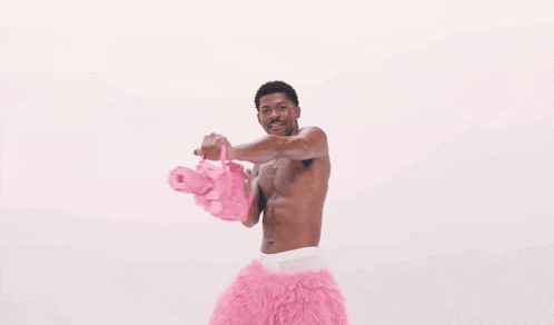 a man is surrounded by pink hearts that are floating around him