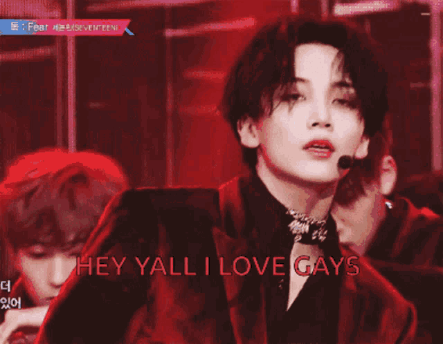 a man in a red suit with the words hey yall i love gays on the bottom