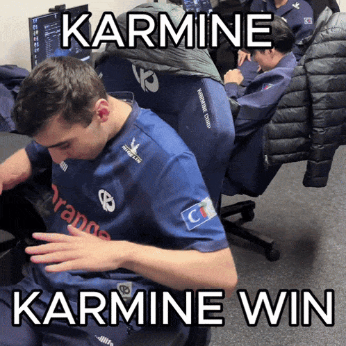 a man in a blue shirt that says karmine