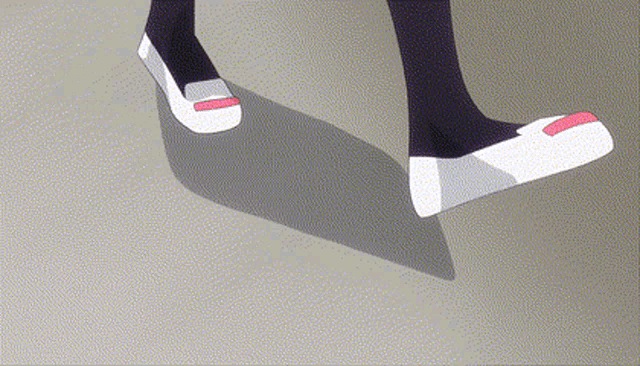 a person wearing a pair of white shoes with a pink stripe