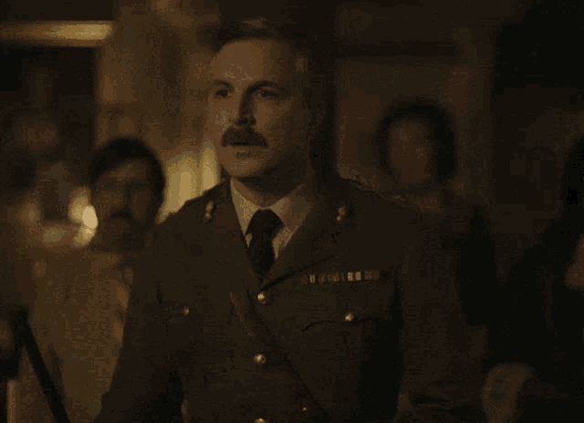 a man in a military uniform with a mustache