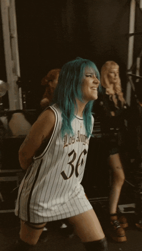 a woman with blue hair is wearing a jersey with the number 36