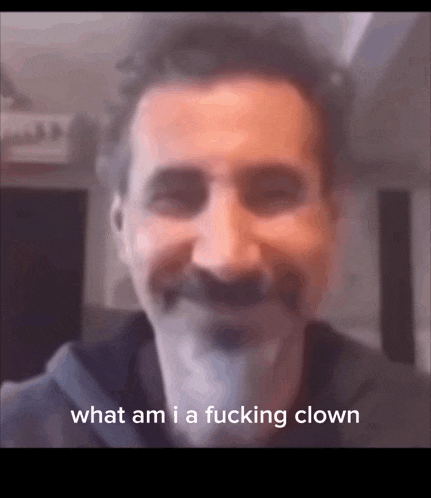 a man with a mustache is smiling and says what am i a fucking clown .