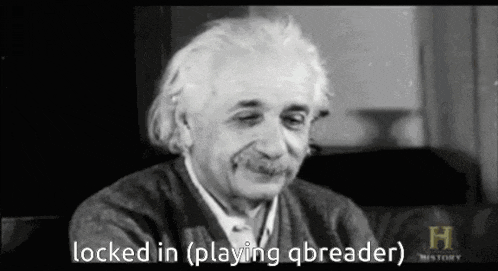 a black and white photo of albert einstein sitting on a couch