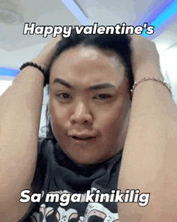 a man is holding his head with his hands and says happy valentine 's sa mga kinakikilig .