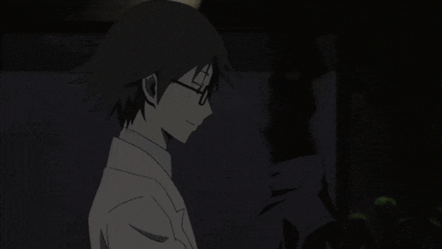a man with glasses and a white shirt is holding a black object