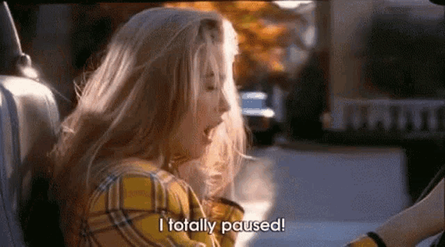 a woman is sitting in the back seat of a car and saying `` i totally paused ! ''