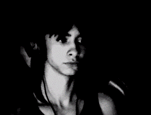 a black and white photo of a woman 's face with headphones on