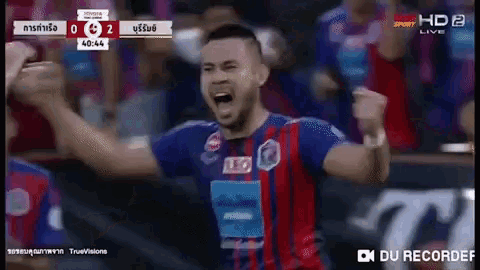 a soccer player is celebrating a goal during a game on a television screen .