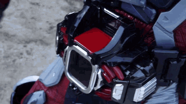 a close up of a person wearing a helmet with a red item in it