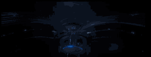 a statue in a dark room with blue lights