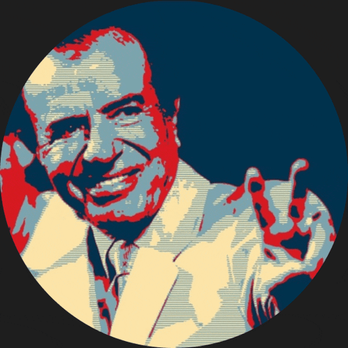 a man in a suit and tie is smiling and giving a peace sign
