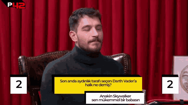 a man is sitting in a chair with a question about anakin skywalker in front of him