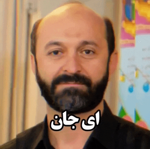 a bald man with a beard is wearing a black shirt with arabic writing on it