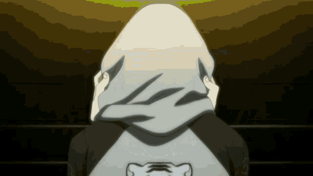a person covering their face with a hoodie that has the letter l on it