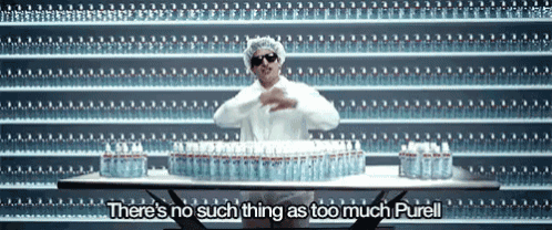 a man stands in front of a wall of water bottles and says " there 's no such thing as too much purell "