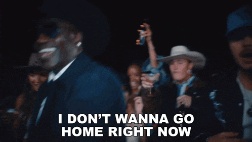 a man in a cowboy hat says " i don t wanna go home right now " in front of a crowd