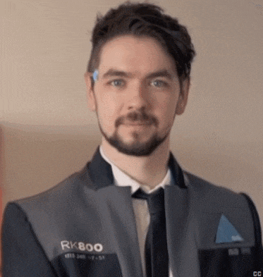 a man with a beard wearing a suit and tie is looking at the camera .