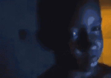 a close up of a person 's face with glowing eyes