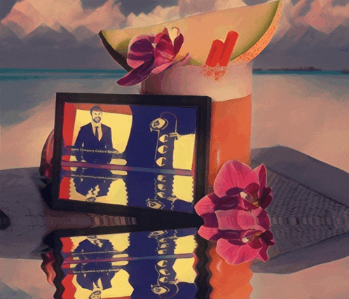 a framed picture of a man playing a guitar next to a drink and flowers