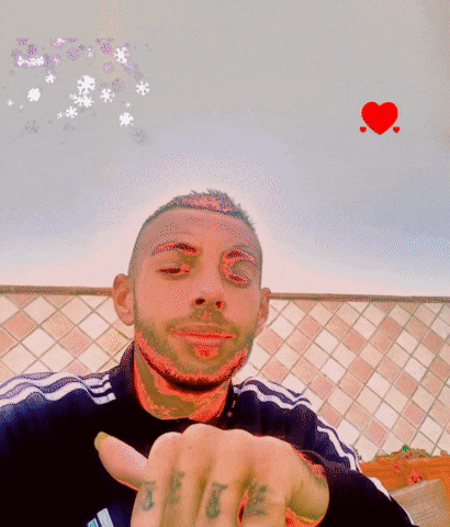 a man with a tattoo on his finger pointing