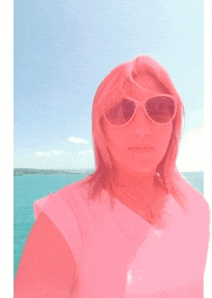 a woman wearing pink sunglasses and a white shirt