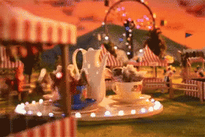 a carnival scene with a tea cup and a pitcher in the foreground
