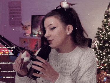 a woman with a bird on her head is holding a microphone