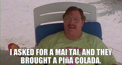 a man is sitting in a chair with the words i asked for a mai tai