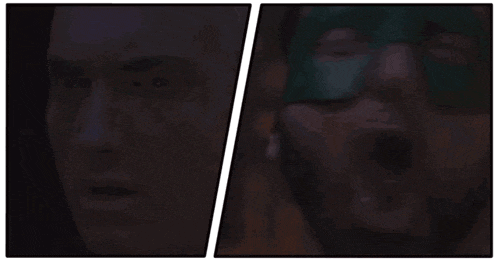 a man wearing a green mask is looking at another man