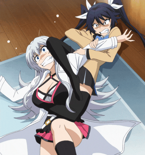 two anime girls are laying on the floor and one is holding the other 's arm