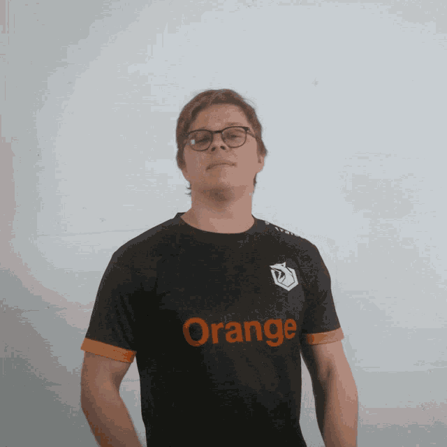 a man wearing a black shirt that says orange on it