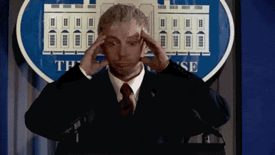 a man in a suit and tie is standing in front of a white house logo