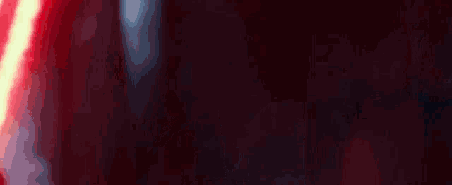 a close up of a red and yellow light coming out of a dark room .