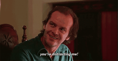 a man is sitting in a chair and saying `` you 're distracting me '' .