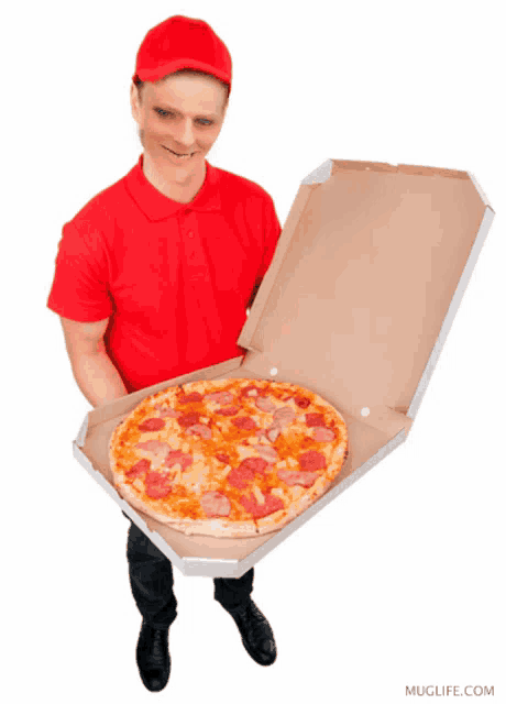 a man in a red shirt is holding a box of pizza