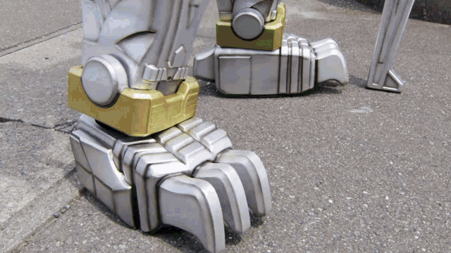 a close up of a robot 's foot with a green light on it