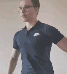 a young man wearing glasses and a blue nike shirt