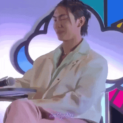 a man is sitting at a table with a microphone in his hand .