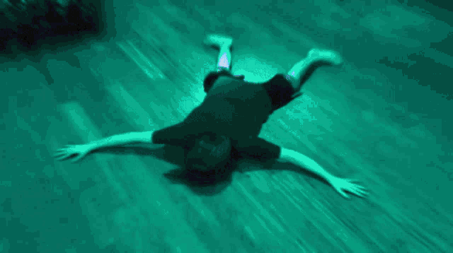 a person is laying on their back on a blue floor