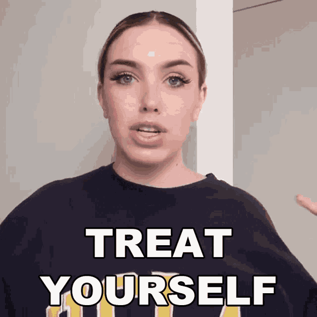 a woman wearing a blue shirt with the words treat yourself on it