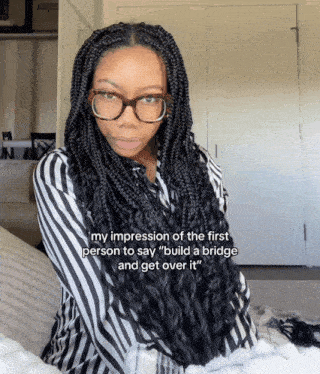 a woman with braids and glasses says her impression of the first person to say build a bridge and get over it